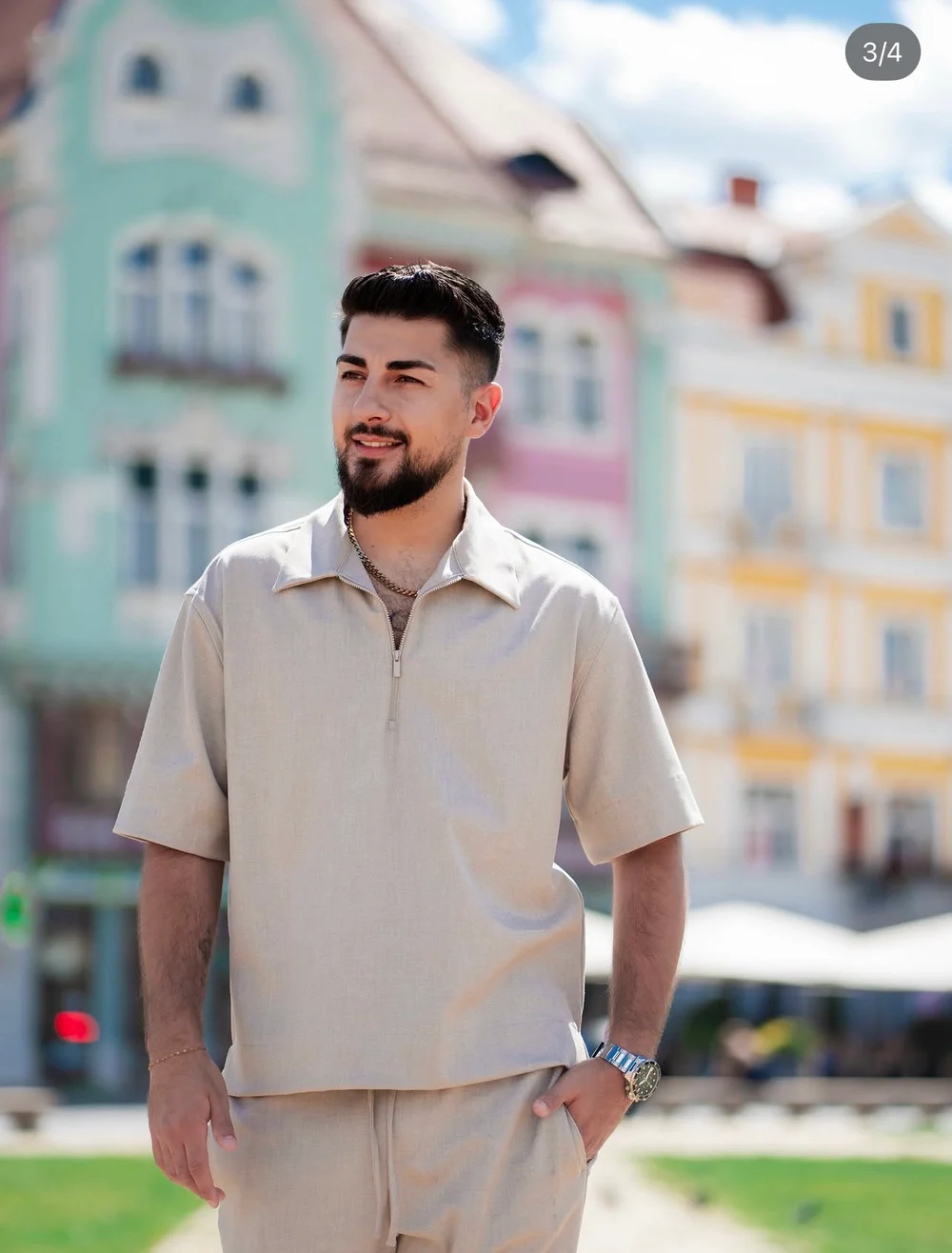 Patrick in a linen outfit among pastel buildings
